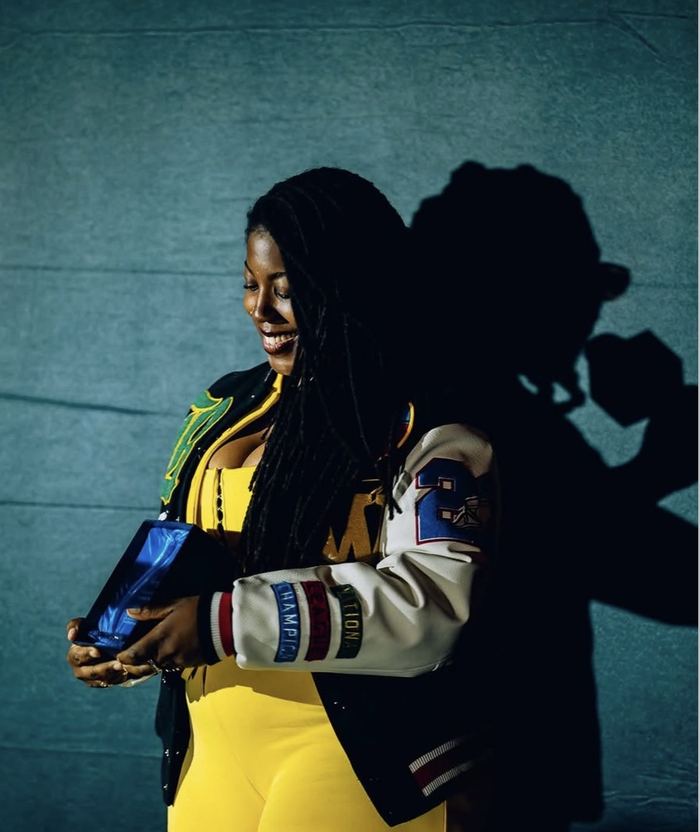 Adebukola Ajao holding an award trophy