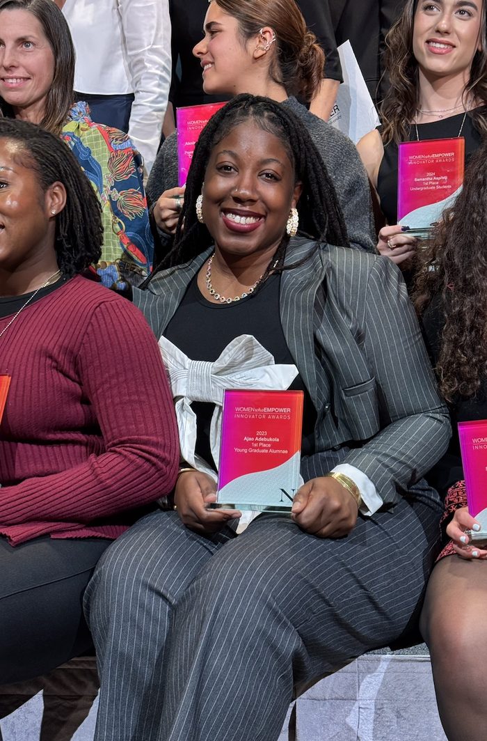 Adebukola Ajao holding her 2023 Women Who Empower Innovator Awards first place trophy